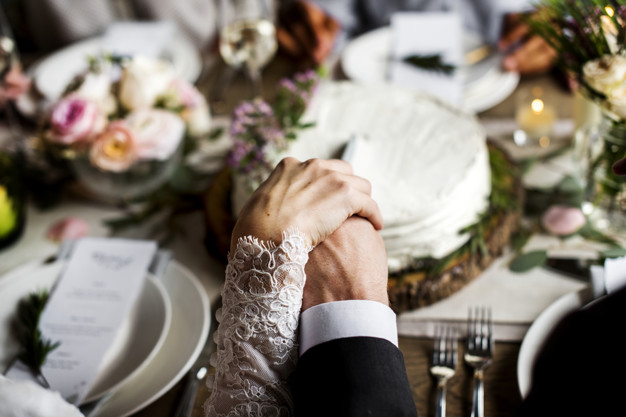 bride-groom-holding-hands-each-other-wedding-reception_53876-92252